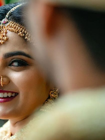 A lovely over the shoulder shot of a bride smiling at her groom. This perspective creates a sense of intimacy and connection.