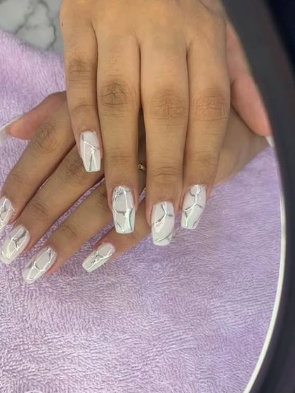 A clean and modern design with a glossy white base and abstract silver lines.