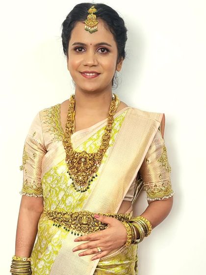 Bride Megha looking radiant for her post-wedding ceremony. The pastel silk saree is draped to be comfortable yet formal, perfect for greeting guests.