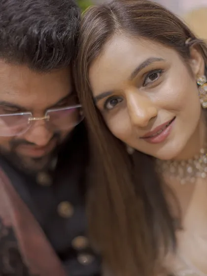 An intimate close-up from an engagement shoot, capturing the couple's soft smiles and the excitement of the moment.