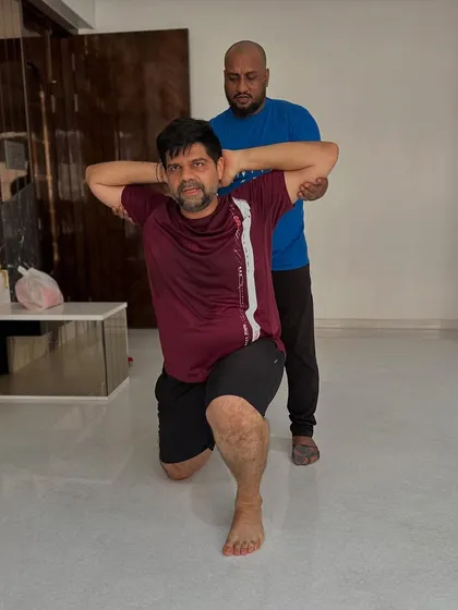 Proven results come from personalized guidance. This image captures a moment of focused effort during an at-home personal training session, targeting leg strength and balance.