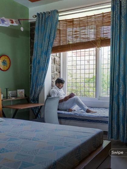 A cozy bay window seat in a bedroom at the Gifty Residence. This is a feature I often include to create small, personal nooks for reading and relaxation, connecting the private space to the outdoors.