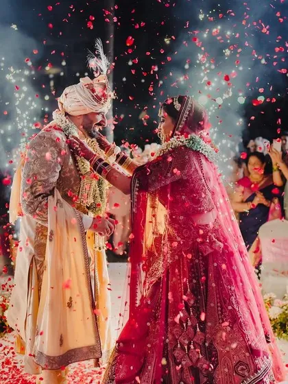 A magical varmala moment, where the couple is showered with rose petals under the spotlight. I focus on creating these picture-perfect memories that you will cherish for a lifetime.