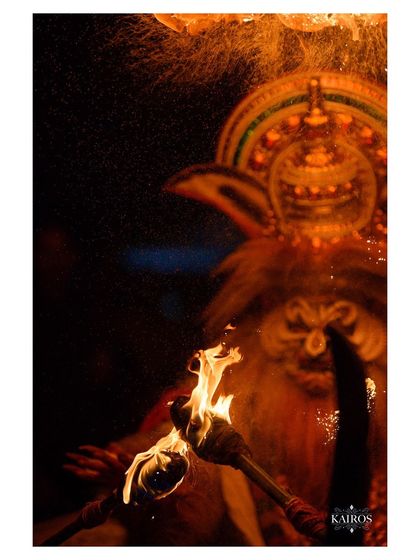 An atmospheric shot using torches to light the scene, creating a raw and ancient feel for this cultural performance.