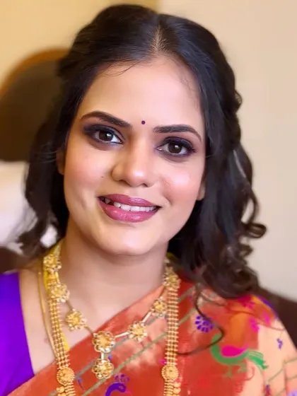 A direct portrait showing the final look. The skin is glowing, the eyes are defined, and the lip color is a perfect match for the Paithani saree.