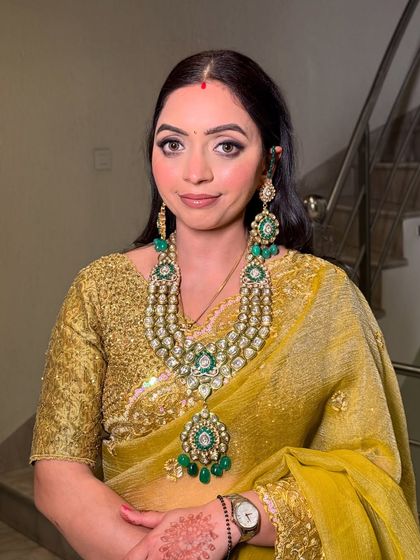 A close-up portrait. The winged eyeliner and soft lip color are a timeless combination for any special occasion.