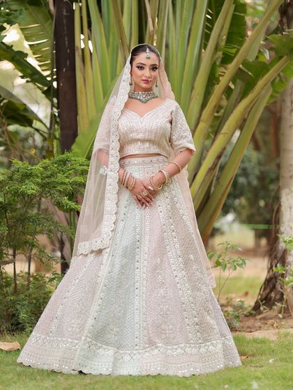 A vision in white. The soft, glowing makeup enhances her features beautifully, creating a look that is both angelic and regal.