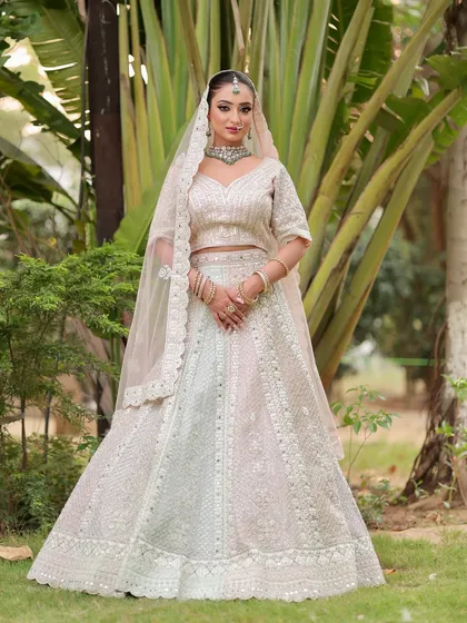 A vision in white. The soft, glowing makeup enhances her features beautifully, creating a look that is both angelic and regal.