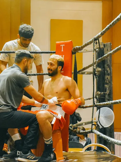Getting patched up between rounds. Boxing is a tough sport that demands resilience and the ability to recover quickly.