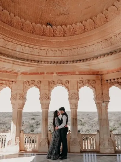 An architectural marvel serves as the backdrop for this beautiful pre-wedding photo. I help plan these shoots to create timeless memories.