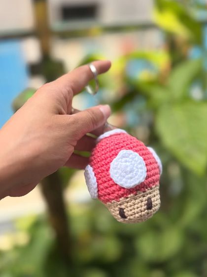 A Super Mario-inspired mushroom keychain. It's a perfect little piece of nostalgia for gamers.