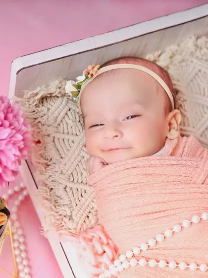 A precious, sleepy smile from the baby in the peach and pink setup. These are the magical moments I always hope to capture.