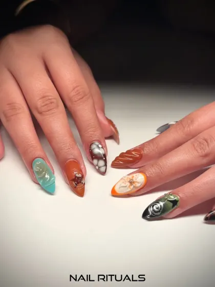 A textured masterpiece on every nail. This set features a variety of 3D designs, including swirls, bubbles, and floral patterns in a mix of earthy and vibrant colors.