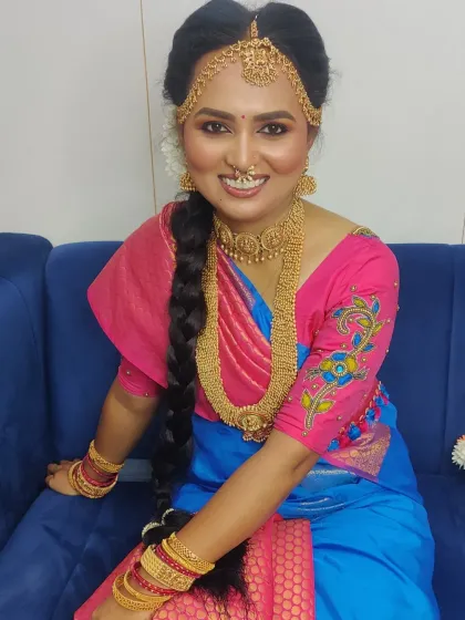 A closer look at the Iyer Madisar drape, showcasing the beautiful way the fabric is styled around the body, complete with traditional jewelry and hairstyle.