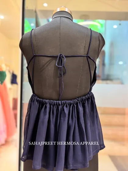 Introducing my signature PEECHA collection. This is a navy blue backless kurti with delicate spaghetti straps and a tie-up detail. It’s all about letting the back do the talking.