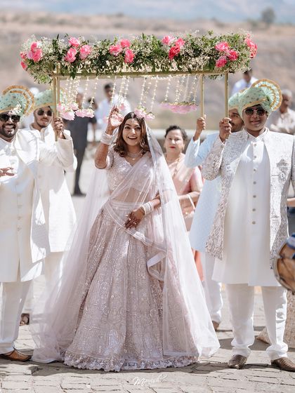 The bride's grand entrance under a beautiful 'phoolon ki chadar,' a moment filled with anticipation and emotion as she walks towards her future.