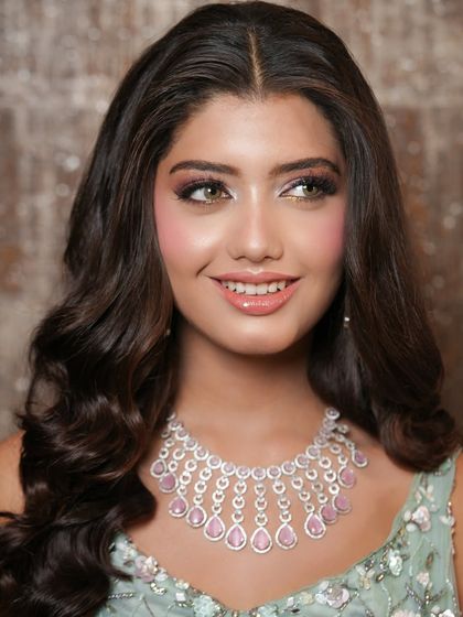 Another beautiful portrait showing off the soft glam makeup. The gentle shimmer on the eyes and the glowing skin create a look that is both sophisticated and effortlessly beautiful.