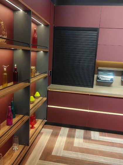 A closer look at the open shelving and rolling shutter unit in our magenta kitchen design. This combination provides both easy-access storage for everyday items and concealed space for appliances.