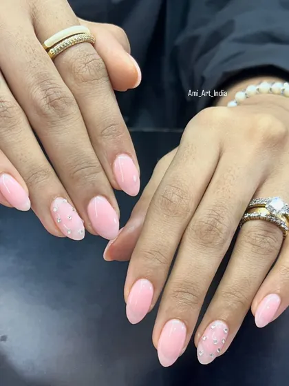 A soft pink set with a beautiful cascade of tiny rhinestones on the accent nails.