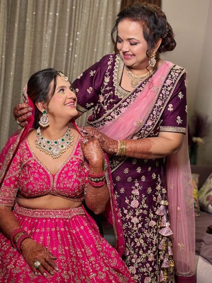 Another beautiful mother-daughter moment. The makeup for both is done to enhance their natural beauty and create a cohesive, elegant look.