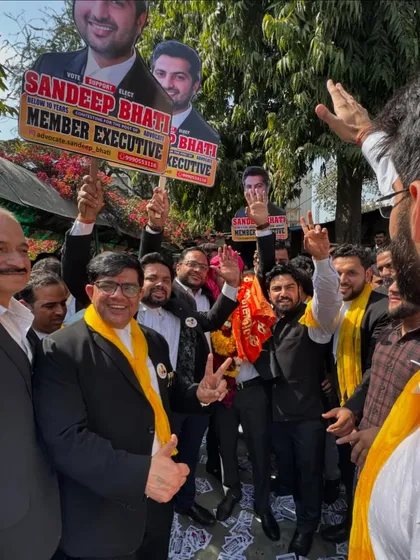Waving to supporters and colleagues during a campaign rally.