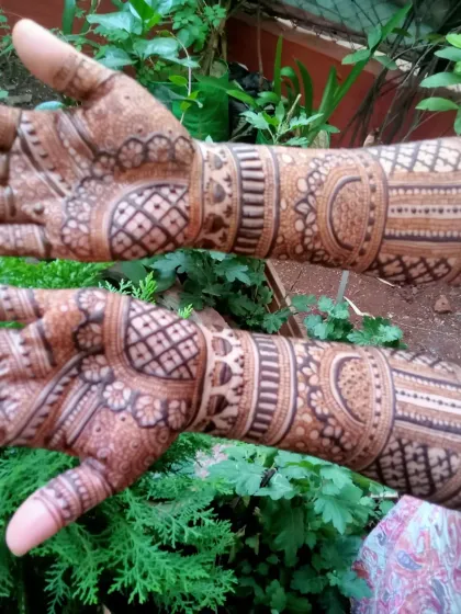 Another view of the same extensive bridal mehendi, highlighting the consistency and detail in the artwork across both hands and arms.