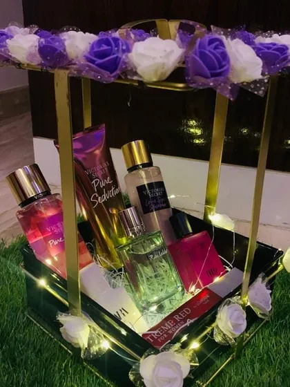 For the one who loves luxury, I create elegant fragrance hampers like this one. This beautiful metal and floral basket is filled with a curated selection of perfumes and body mists from brands like Victoria's Secret and Zara, making it a perfect gift for birthdays or anniversaries.