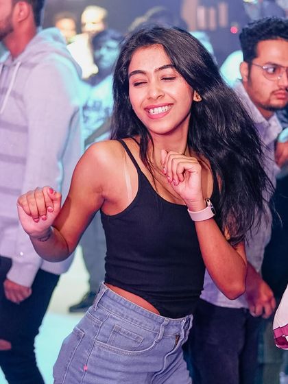 A guest dancing with a huge smile. This is the vibe I create every Saturday.
