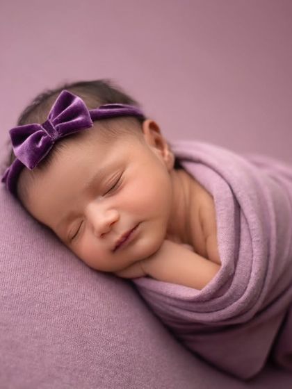 Pretty in purple. This side-lying pose is perfect for showing off your baby's sweet profile, all while they are comfortably wrapped and sleeping.