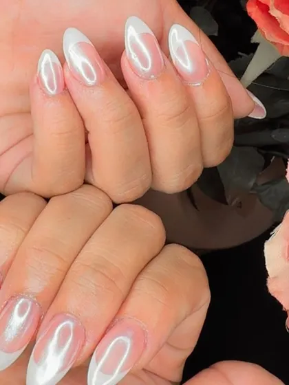 A final look at the French holochrome nails, set against a soft floral background.