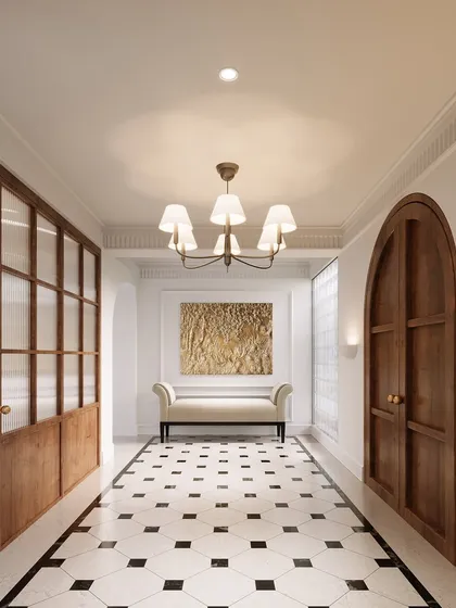 This vestibule was envisioned as a gentle, elegant transition into the home, filled with European character. The classic black-and-white marble flooring, warm wood tones, and ribbed glass partition create a balance of privacy and light, inviting you to pause and feel at home.