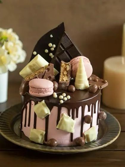 For the ultimate chocolate lover's birthday, our overloaded drip cake is a dream come true. It's piled high with chocolate bars, macarons, and white chocolate chunks.