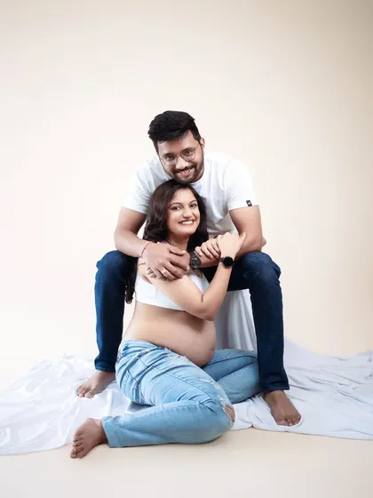 Relaxed, happy, and full of love. This casual studio setup with simple white fabric and jeans allows their joy to be the centerpiece. It’s a snapshot of their comfortable, happy life as they wait for their baby.