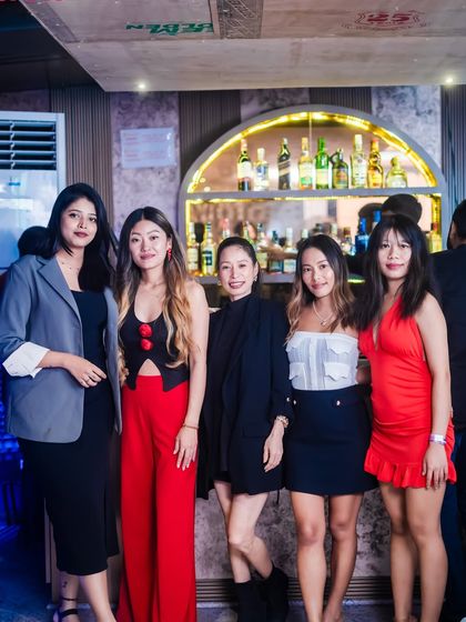 A group of friends dressed up for a night out at Happy Brew.