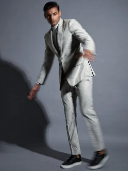 Movement and tailoring in perfect harmony. This shot from a designer campaign captures the dynamic energy of a well-fitted jacquard suit, demonstrating how formal wear can be both structured and expressive.