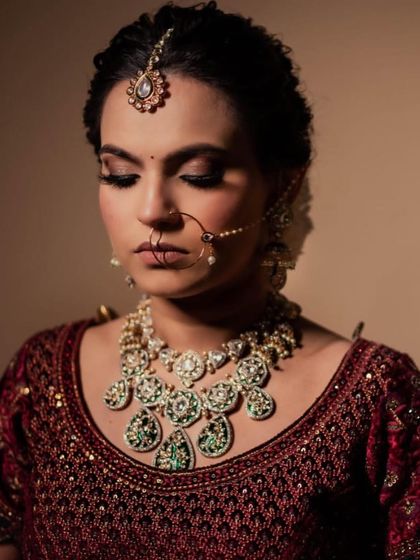 A close-up portrait focusing on the stunning eye makeup and the beautiful kundan jewelry.