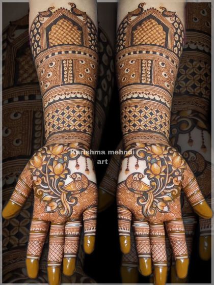 A beautiful design featuring peacocks surrounded by lotus flowers on the palms. The arms are adorned with traditional jharokha windows and geometric patterns, creating a rich and detailed look.