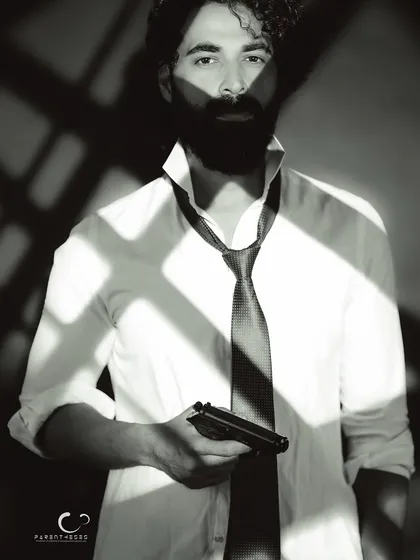 Black and white photography strips away everything but the essential. This noir-inspired portrait uses dramatic shadows to build a cinematic narrative of mystery and intensity, proving that the most powerful stories are often told in monochrome.