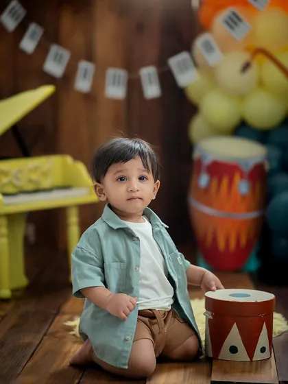 Getting ready to play the drums. This music-themed setup includes a variety of mini instruments for your little one to explore.