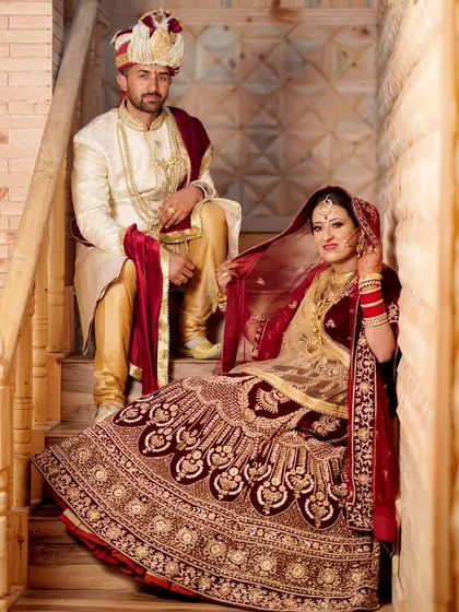 A royal portrait of the bride and groom in their stunning wedding attire. I use classic poses and settings like this staircase to create elegant and timeless wedding photographs.