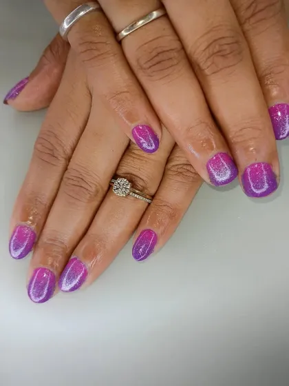 A vibrant purple and pink ombre with a glittery finish, perfect for those who love a pop of color.