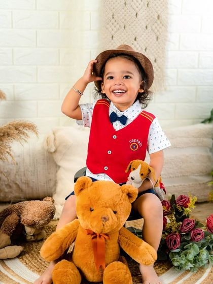 A baby's laugh is the sweetest sound. This little boy's joyful expression while playing with his teddy bears is absolutely priceless.