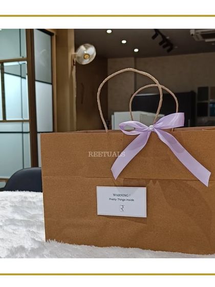 Sometimes, the simplest packaging makes the biggest statement. This birthday gift is placed in a clean brown paper bag with a lilac ribbon and a fun warning label that says "Pretty Things Inside".