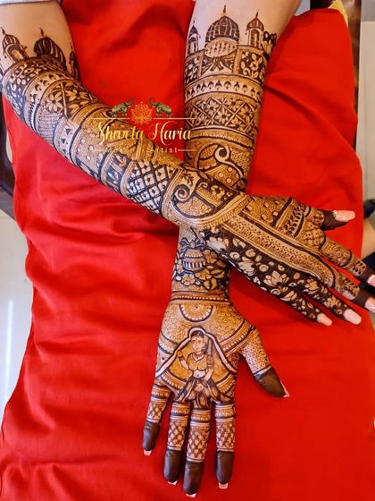 The full view of a stunning bridal mehendi, with both hands brought together to show the symmetry and flow of the intricate design.
