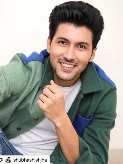 A happy, smiling shot of Shubhashish Jha after a styling session. His hair is styled for volume and a touch of classic charm.