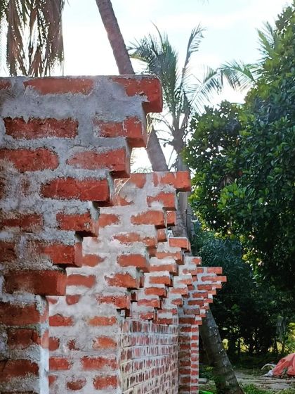 A detail of corbelling brickwork, where each layer steps out slightly. This method is used to create arches and other decorative structural elements.
