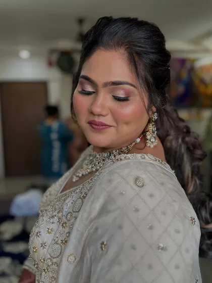 A close-up of the makeup, showing the soft pink tones on the eyes and lips.