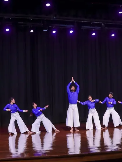 A wide shot of our dance troupe on stage during the 'KALKI' performance. The coordinated costumes, stage lighting, and synchronized poses are all part of the complete production package we deliver.