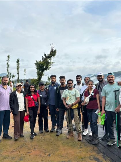 A group of trekkers on a trail, with misty mountains in the background. This is a typical view from our Western Ghats adventures.