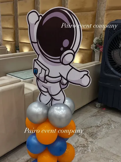 An astronaut cutout prop on a balloon base. These small, themed details are perfect for placing around the venue to maintain the party's theme throughout the space.